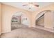 An open floor plan with beige walls and a ceiling fan at 6101 W Sunnyside Dr, Glendale, AZ 85304