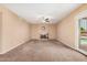 Spacious living room with a fireplace, ceiling fan and access to outdoor pool area at 6101 W Sunnyside Dr, Glendale, AZ 85304