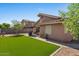 Backyard features artificial turf, gravel landscaping, and a patio seating area at 612 E Racine Pl, Casa Grande, AZ 85122