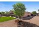 Backyard features artificial turf, gravel landscaping, and a patio seating area at 612 E Racine Pl, Casa Grande, AZ 85122