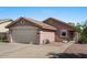 Lovely single-story home with a spacious two-car garage, low maintenance landscaping, and desert-style front yard at 612 E Racine Pl, Casa Grande, AZ 85122