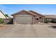 Charming single-story home features a two-car garage, low maintenance landscaping, and a cozy porch area at 612 E Racine Pl, Casa Grande, AZ 85122