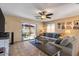 Inviting living room with tile floors, a ceiling fan, and sliding glass doors that lead to the outdoor space at 612 E Racine Pl, Casa Grande, AZ 85122