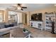 Cozy living room area with access to the kitchen, comfortable sofa, and a large television for entertainment at 612 E Racine Pl, Casa Grande, AZ 85122