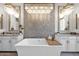 The bathroom features a freestanding tub with wooden tray, chic lighting, a decorative wall and double sink granite vanity at 6320 E Gloria Ln, Cave Creek, AZ 85331