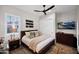 Cozy bedroom with a ceiling fan, closet, TV, and a dresser on top of plank flooring at 6320 E Gloria Ln, Cave Creek, AZ 85331