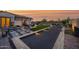 Backyard bocce ball court enhanced with landscape lighting, adjacent to an outdoor lounge, and desert plants at 6320 E Gloria Ln, Cave Creek, AZ 85331