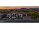 Stunning home with desert landscaping, mountain views, arched windows, three car garage, and a charming front courtyard at 6320 E Gloria Ln, Cave Creek, AZ 85331