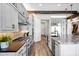 Kitchen boasts gray cabinets, stainless appliances, granite counters, and an island with bar seating at 6320 E Gloria Ln, Cave Creek, AZ 85331