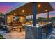 Outdoor kitchen with granite countertops, a built-in grill, and ample bar seating at 6320 E Gloria Ln, Cave Creek, AZ 85331