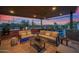 Inviting covered patio with comfortable seating, a grill, and sunset views at 6320 E Gloria Ln, Cave Creek, AZ 85331