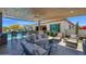 Covered patio boasting a built-in bar, comfortable seating, and a beautiful pool area at 6320 E Gloria Ln, Cave Creek, AZ 85331