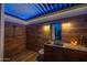 Modern outdoor shower and sink area boasts wooden paneled walls, ample lighting, and sleek fixtures at 6320 E Gloria Ln, Cave Creek, AZ 85331