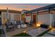 Covered patio area showcasing comfortable seating, manicured yard, a lounge, an outdoor shower, and ample lighting at 6320 E Gloria Ln, Cave Creek, AZ 85331