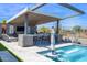 Poolside bar with seating, a water feature, and desert views at 6320 E Gloria Ln, Cave Creek, AZ 85331