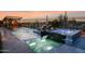 Inviting pool with a lounge area, hot tub, and stunning desert sunset views at 6320 E Gloria Ln, Cave Creek, AZ 85331