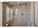 Elegant shower with neutral tiling, a glass door, a built-in niche, and modern fixtures at 6320 E Gloria Ln, Cave Creek, AZ 85331