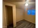 This bedroom offers a ceiling fan, a closet, modern vinyl flooring and a bright window at 6447 W Piccadilly Rd, Phoenix, AZ 85033