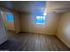This bedroom provides a spacious layout, modern vinyl flooring and a bright window at 6447 W Piccadilly Rd, Phoenix, AZ 85033