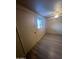 This bedroom offers a closet, bright window, ceiling fan, and modern vinyl flooring at 6447 W Piccadilly Rd, Phoenix, AZ 85033