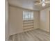 This bedroom has hard surface floors, a ceiling fan, and built in shelves at 6447 W Piccadilly Rd, Phoenix, AZ 85033