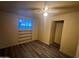 This cozy bedroom features a ceiling fan, built-in shelves, and modern vinyl flooring for a clean, contemporary look at 6447 W Piccadilly Rd, Phoenix, AZ 85033
