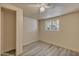 Comfortable bedroom with hard surface floors, a ceiling fan, and large window at 6447 W Piccadilly Rd, Phoenix, AZ 85033