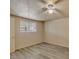 Bedroom with neutral paint, ceiling fan, wood-look flooring, and natural light from the window at 6447 W Piccadilly Rd, Phoenix, AZ 85033