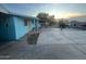 View of exterior side and back with a concrete parking area and chain link fence at 6447 W Piccadilly Rd, Phoenix, AZ 85033