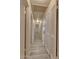 Bright hallway with white trim and doors, leading to living areas, and featuring wood-look flooring at 6447 W Piccadilly Rd, Phoenix, AZ 85033