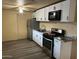 Simple kitchen, showcasing the stove, refrigerator and flooring in the home at 6447 W Piccadilly Rd, Phoenix, AZ 85033