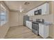 Kitchen features white cabinets, stainless appliances, and hard surface floors at 6447 W Piccadilly Rd, Phoenix, AZ 85033