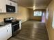 Open kitchen layout with stainless steel appliances, modern cabinets and plank flooring at 6447 W Piccadilly Rd, Phoenix, AZ 85033