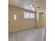 Living room featuring wood-look flooring, neutral walls, and an exterior door with sidelight window at 6447 W Piccadilly Rd, Phoenix, AZ 85033