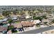 A high-angle aerial shot displaying the layout of houses, landscaping, swimming pools and park at 6457 E Encanto St, Mesa, AZ 85205