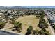 A high-angle, wide aerial view of a park area in a residential neighborhood with mature trees at 6457 E Encanto St, Mesa, AZ 85205