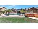 Backyard featuring pool, patio, mature trees and desert landscaping at 6457 E Encanto St, Mesa, AZ 85205
