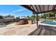 Backyard features pool, grill and covered patio with landscaping at 6457 E Encanto St, Mesa, AZ 85205