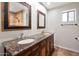 Bathroom features a dual sink vanity with granite countertop and framed mirrors at 6457 E Encanto St, Mesa, AZ 85205