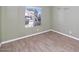 Bright bedroom features light green walls, wood flooring and a large window at 6457 E Encanto St, Mesa, AZ 85205