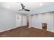 Carpeted room features a ceiling fan, recessed lights and a white exterior door at 6457 E Encanto St, Mesa, AZ 85205