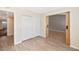 Spacious bedroom with wood-look floors, white trim and a barn door at 6457 E Encanto St, Mesa, AZ 85205