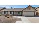 Charming single-story home with desert landscaping and a two-car garage at 6457 E Encanto St, Mesa, AZ 85205