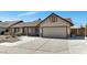 Single-story home with desert landscaping, covered entry, and a two-car garage at 6457 E Encanto St, Mesa, AZ 85205