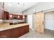 Stylish kitchen featuring stainless appliances, granite countertops, and custom cabinetry at 6457 E Encanto St, Mesa, AZ 85205