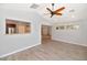 Open-concept living area with wood-look flooring, a vaulted ceiling, and a view to the kitchen at 6457 E Encanto St, Mesa, AZ 85205