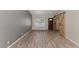 Bright living room with wood floors, barn doors, and plenty of natural light at 6457 E Encanto St, Mesa, AZ 85205