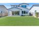 Expansive backyard with lush green lawn, covered patio, and a well-maintained landscape at 6743 N 9Th Dr, Phoenix, AZ 85013