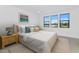 Cozy bedroom with a comfortable bed, stylish nightstand, and natural light from multiple windows at 6743 N 9Th Dr, Phoenix, AZ 85013