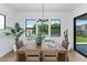 Modern dining room with stylish lighting, table set, and view to backyard at 6743 N 9Th Dr, Phoenix, AZ 85013
